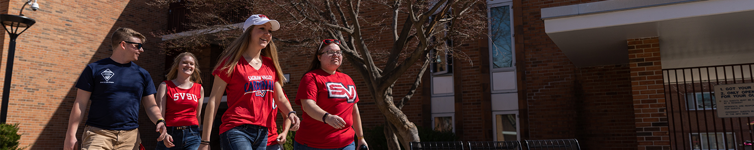 4 students walking around campus